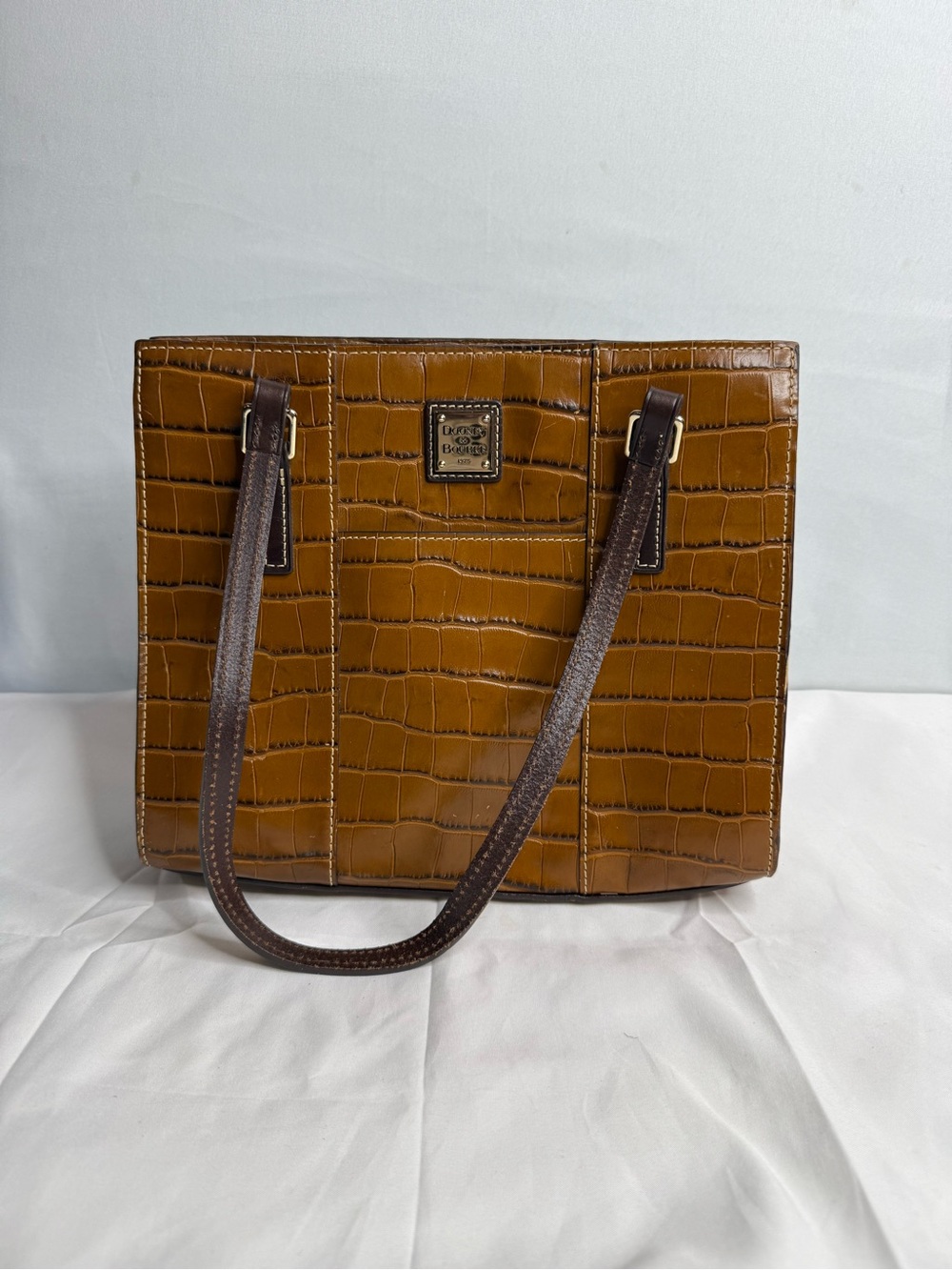 Brown crocodile-embossed tote bag by Dooney & Bourke